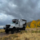 A photo of the Adventure Truck driving through a grassy field